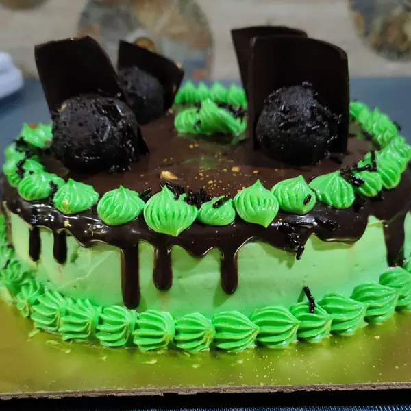 Chocolate drip birthday cake with green piping, Mumbai