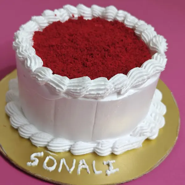 Red velvet cake with a name piped on the board, Borivali West
